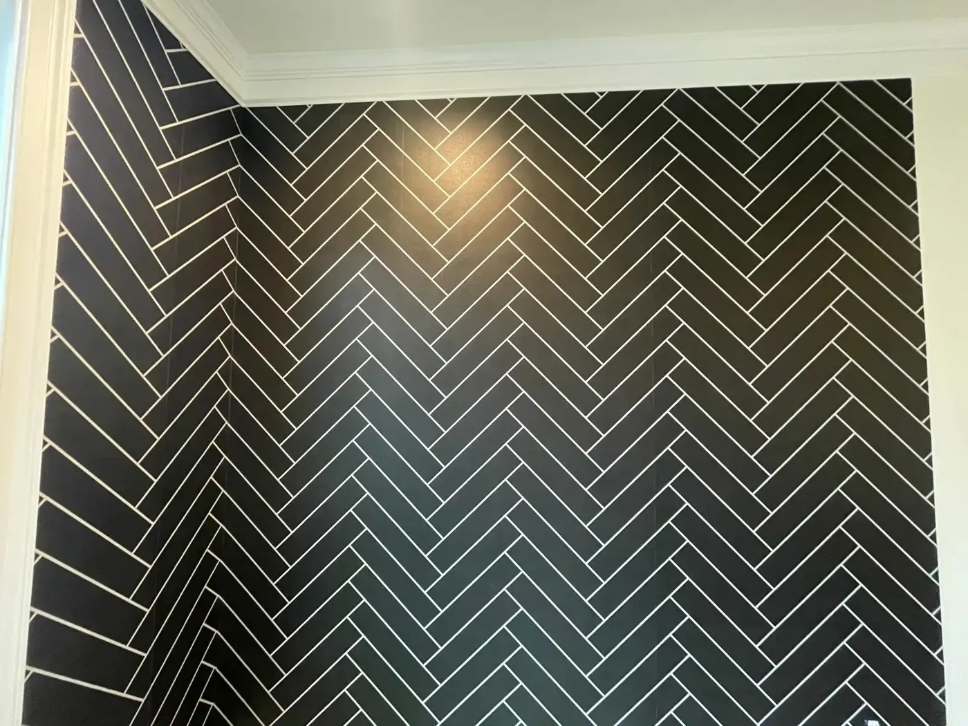 Dark geometric wallpaper in a herringbone-style pattern