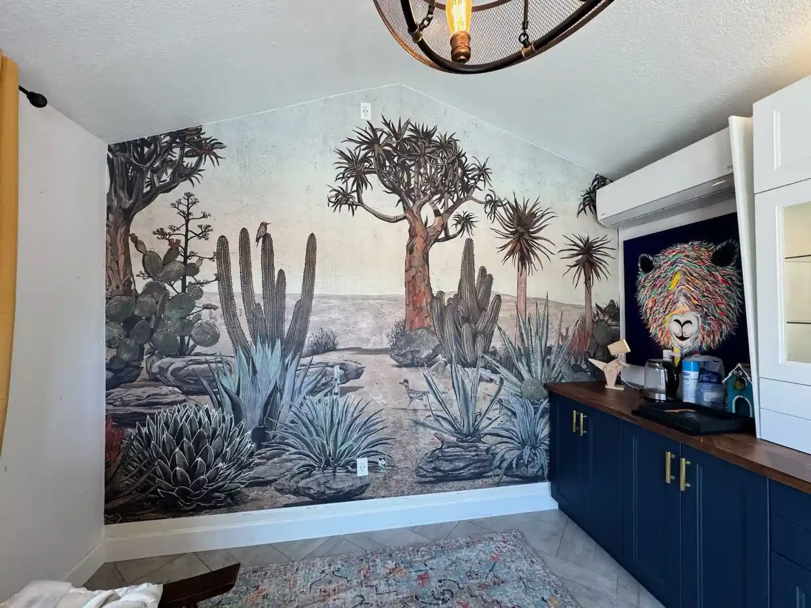 A finished interior with a dramatic wallpaper mural and dark cabinetry